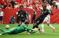Cyle Larin beats Qatar goalkeeper Mahmoud Abunada to open the scoring in Vancouver. Photograph: Anne-Marie Sorvin/IMAGN/Reuters