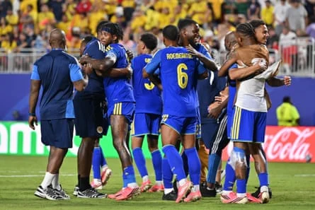 Players of Curaçao embrace after claiming a famous point. Photograph: Amy Kontras/EPA