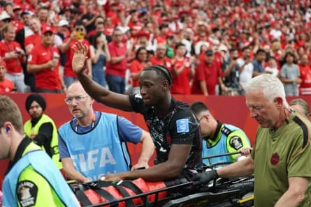 Ismaël Koné acknowledges the crowd as he’s stretchered off following his injury. Photograph: Emma Peterson/AP