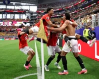 Hossam Abdelmaguid (right) is mobbed by teammates after scoring Egypt’s winning penalty. Photograph: Kevin C Cox/Getty Images
